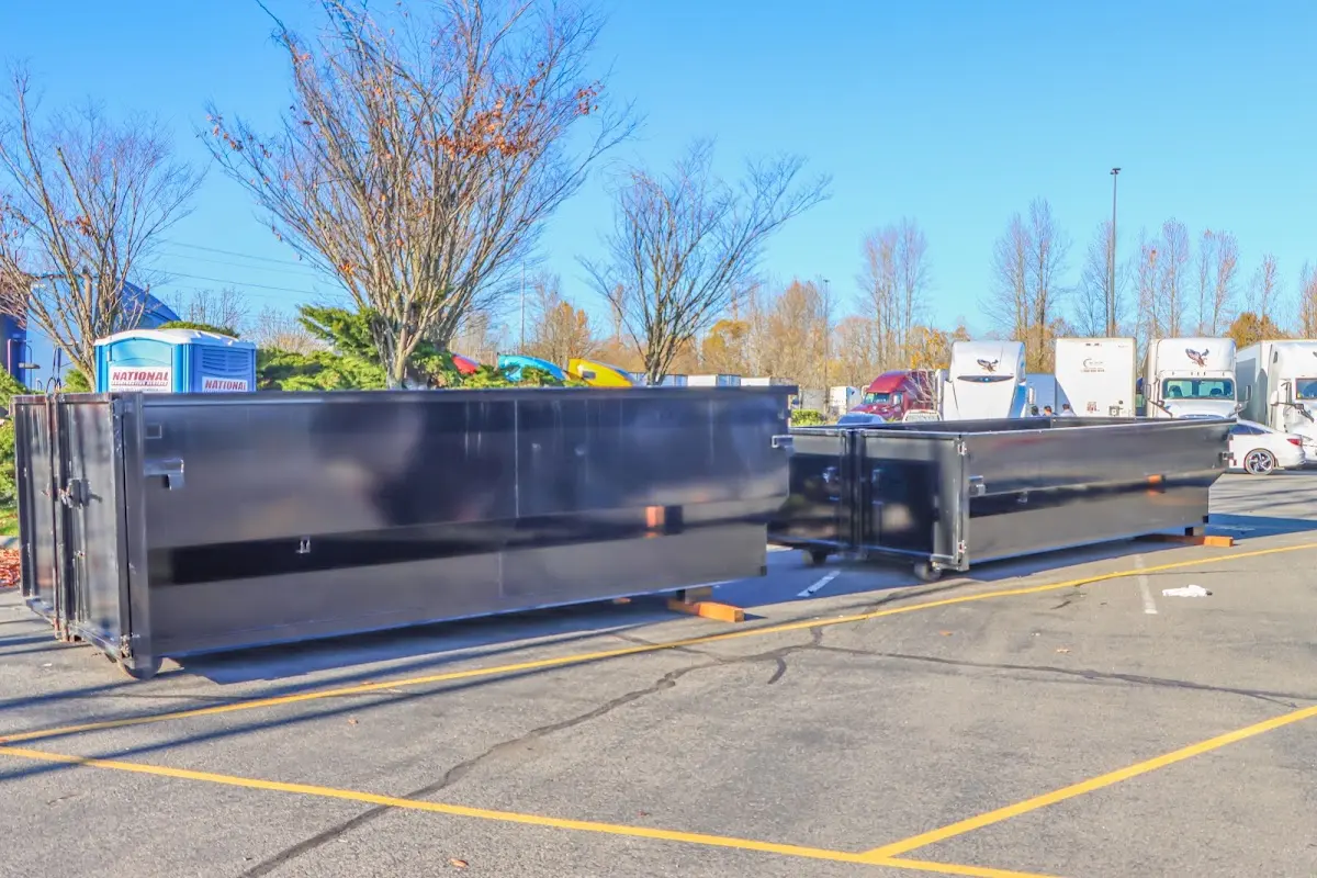 Professional dumpster rental service with roll-off container on residential driveway in Lake Los Angeles